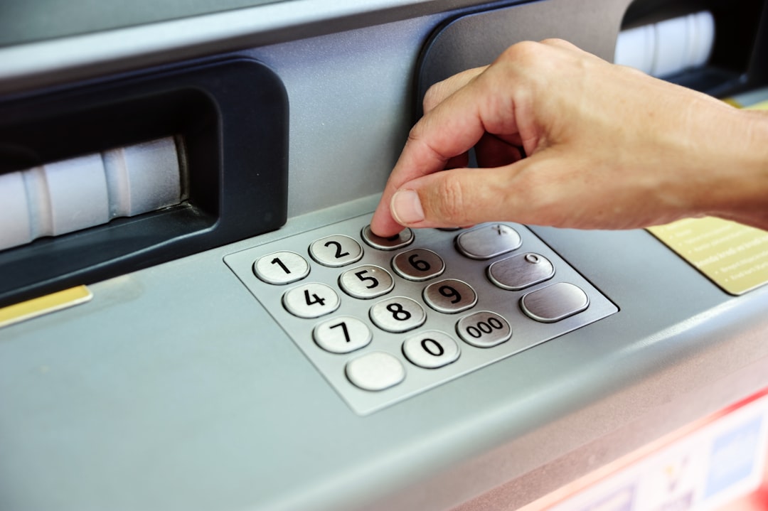 Woman is taking cash from atm